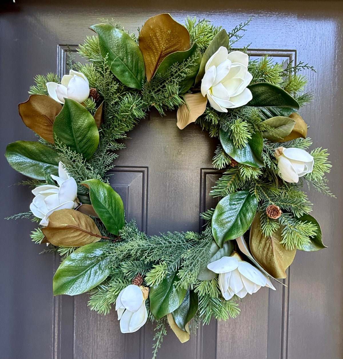     Handcrafted real touch magnolia wreath on a black front door